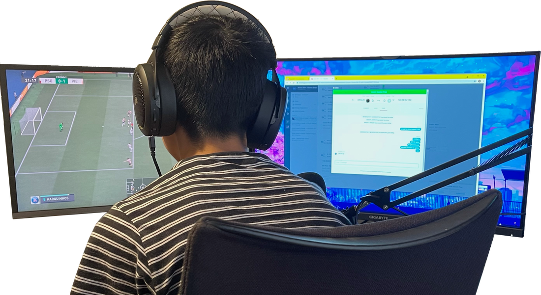Student competing in a FIFA esports match with dual monitors and headset